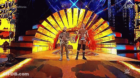 Two Wrestlers On Stage In Front Of Sun GIF