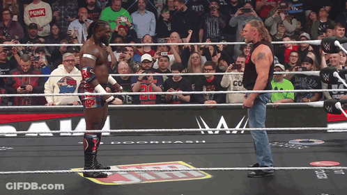 Two Wrestlers One In Punk Shirt GIF