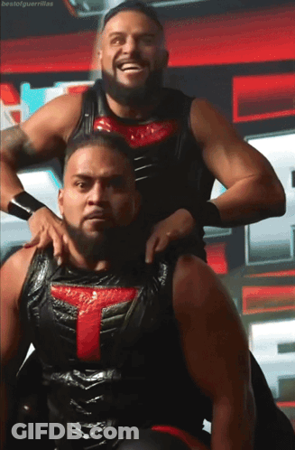 Two Wrestlers Posing One With Red T GIF