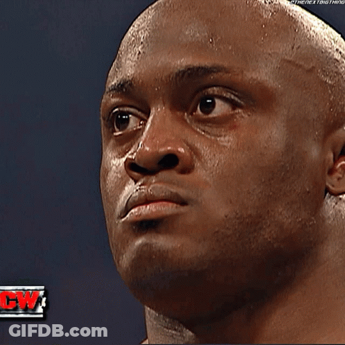 Two Wrestlers Standing In A Ring With A Yellow Shirt That Says Event Staff GIF