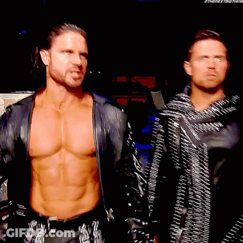 Two Wrestlers Standing In Dark Room Shirtless GIF