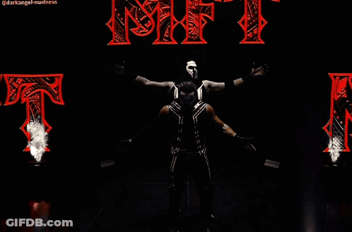 Two Wrestlers Standing In Front Of NFT Sign GIF