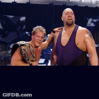 Two Wrestlers Standing Next To Logo GIF