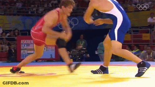 Two Wrestlers Wrestling In Front Of Askren USA Hung Sign GIF