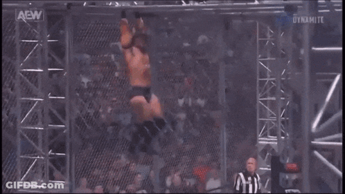 Two Wrestlers Wrestling In Ring With AEW Logo GIF