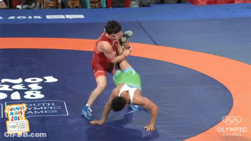 Two Wrestlers Wrestling On Olympic Channel Mat GIF