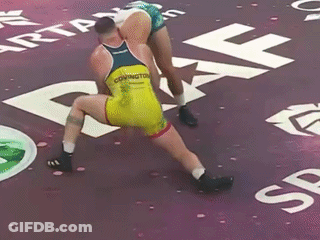 Two Wrestlers Wrestling On Purple Mat, One Named Covington GIF