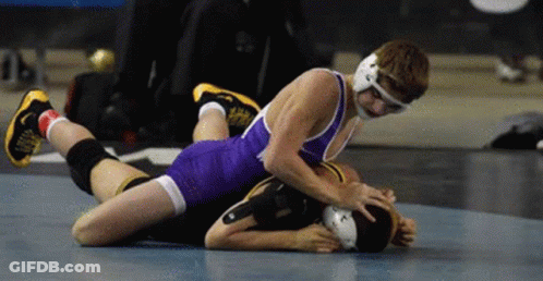 Two Wrestlers Wrestling One Laying On Other's Back GIF