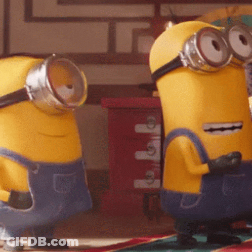 Two Yellow Minions Wearing Blue Overalls And Goggles GIF