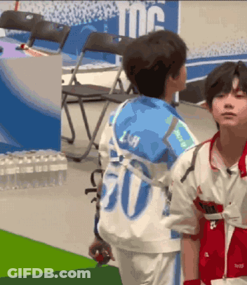Two Young Boys Are Standing Next To Each Other And One Has The Number 20 On His Back GIF