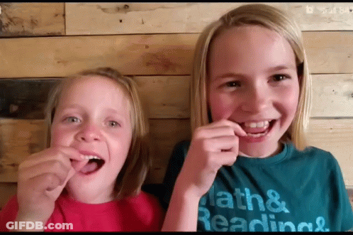 Two Young Girls Wearing Math And Reading T-Shirts GIF