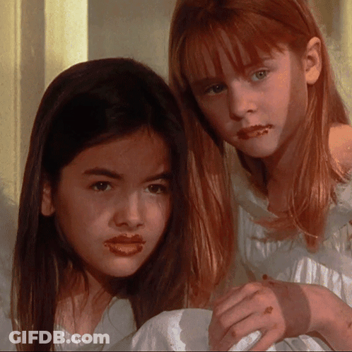 Two Young Girls With Chocolate On Lips GIF