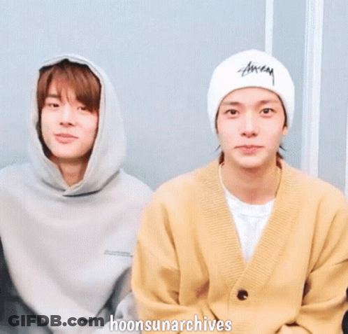 Two Young Men Are Holding Hands With The Words Hoonsunarchives Written Below Them GIF