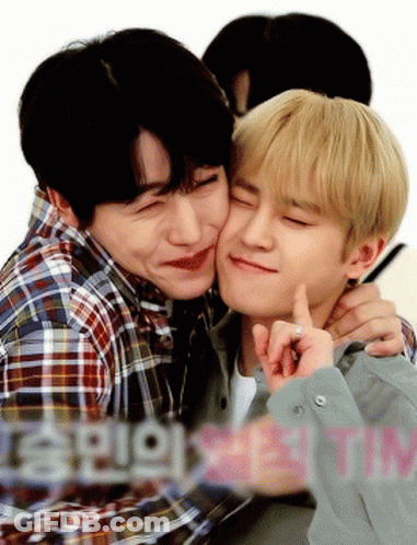 Two Young Men Are Hugging And One Of Them Is Kissing The Other 'S Cheek GIF