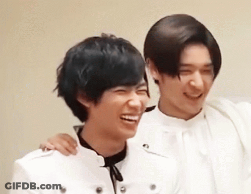 Two Young Men Are Laughing And Hugging Each Other . GIF
