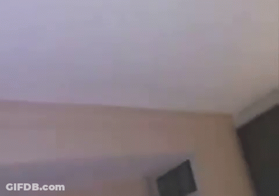 Two Young Men Are Laughing And Looking Up At The Sky While Sitting On A Bed . GIF