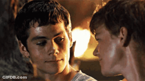 Two Young Men Are Looking At Each Other In A Close Up GIF