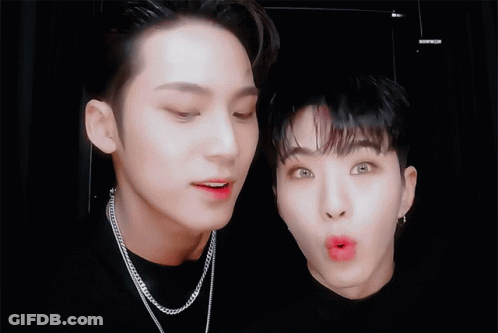 Two Young Men Are Making Funny Faces And One Of Them Is Wearing A Chain Necklace GIF