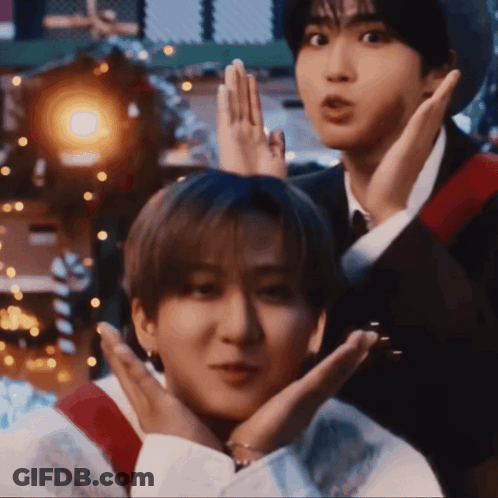 Two Young Men Are Making Funny Faces With Their Hands Over Their Faces GIF
