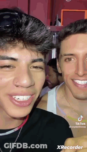 Two Young Men Are Smiling For The Camera And One Has A Nose Ring On His Nose . GIF