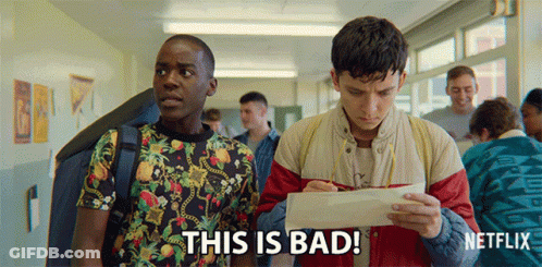 Two Young Men Are Standing In A Hallway And One Of Them Is Holding A Piece Of Paper That Says This Is Bad On It GIF