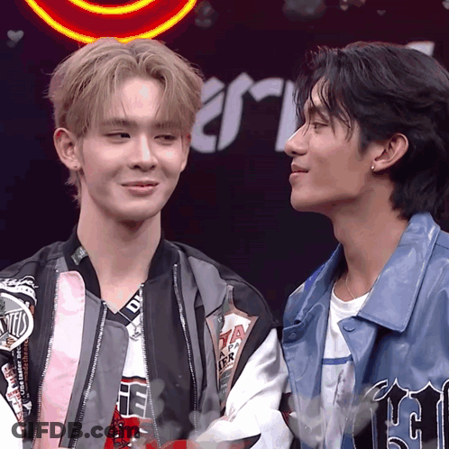 Two Men Standing, One With DTM Jacket GIF