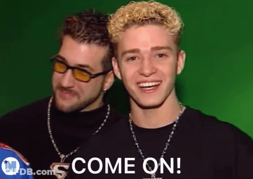 Two Young Men Are Standing Next To Each Other And One Of Them Is Smiling And The Other Is Saying Come On . GIF