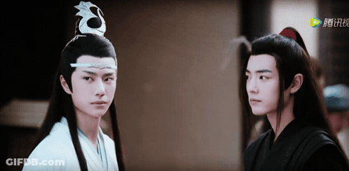 Two Young Men Are Standing Next To Each Other And One Of Them Is Wearing A White Robe GIF