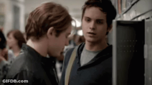 Two Young Men Standing In Locker Room GIF