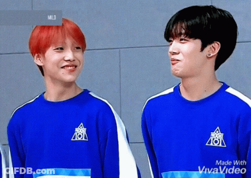Two Young Men Are Standing Next To Each Other Wearing Blue Shirts That Say 101 On Them . GIF