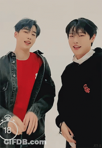Two Young Men Are Standing Next To Each Other With The Number 18 In The Circle GIF