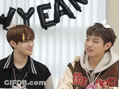 Two Young Men Beside New Year Sign GIF