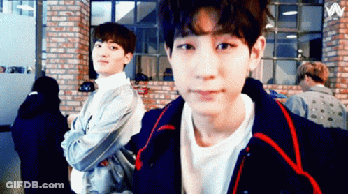 Two Young Men By Brick Wall With Letter W GIF