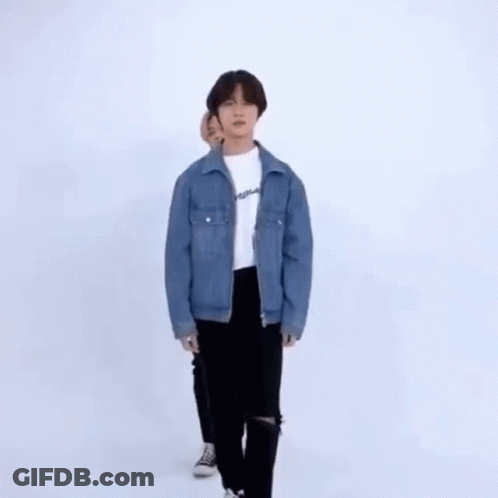 Two Young Men Dancing In Front Of White Wall GIF