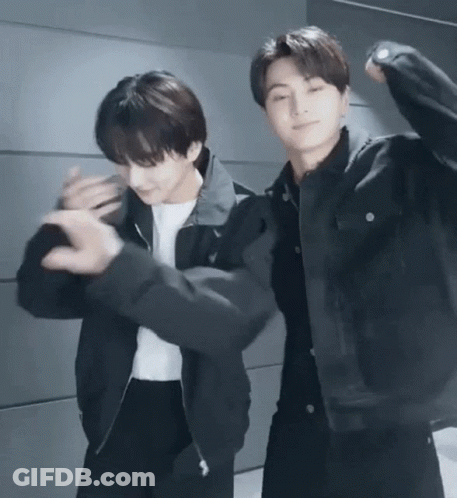 Two Young Men Dancing Next To Each Other GIF