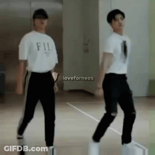 Two Young Men Dancing, One In FIL Shirt GIF
