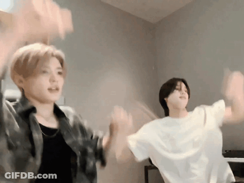 Two Young Men Dancing With Hands In The Air GIF