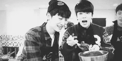 Two Young Men Eating In Kitchen GIF