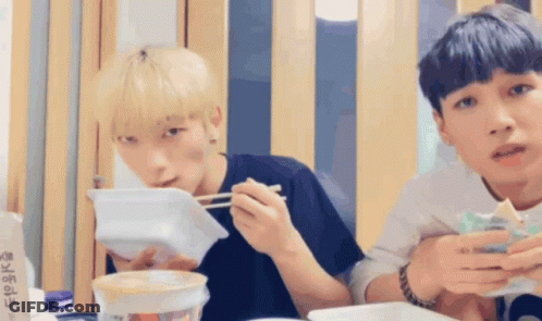 Two Young Men Eating With Chopsticks GIF