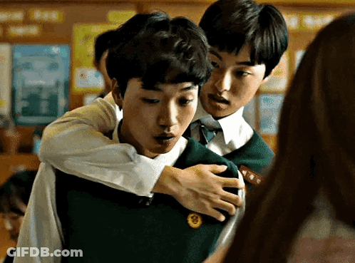 Two Young Men Hugging In Classroom GIF