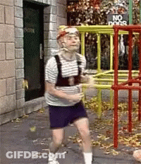 Two Young Men Hugging One Making Heart With Hands GIF