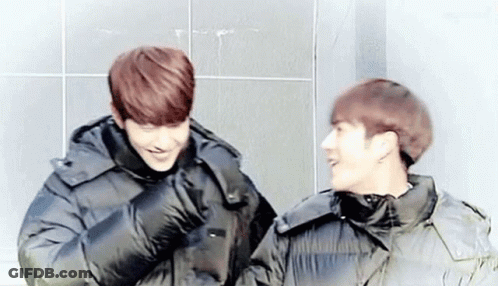 Two Young Men In Black Jackets Laughing GIF