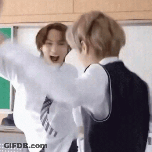 Two Young Men In School Uniforms Standing In Classroom GIF