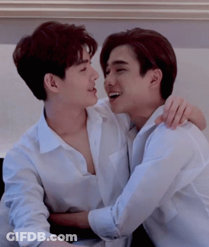 Two Young Men In White Shirts Hugging GIF
