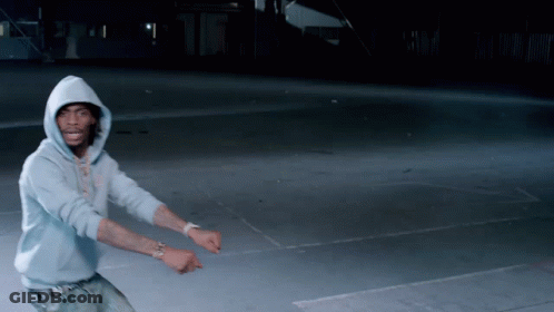 Two Young Men Laughing In Front Of Popsugar Flag At Comic Con GIF