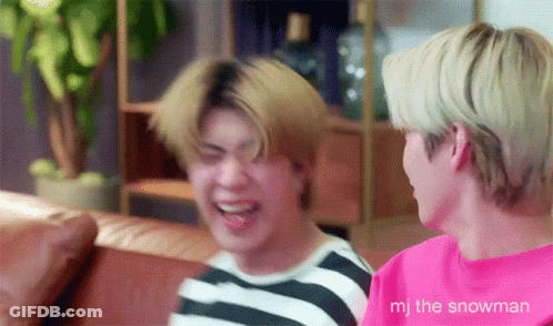 Two Young Men Laughing On Couch GIF
