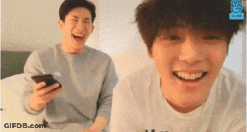Two Young Men Laughing One Holding Phone GIF