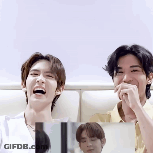 Two Young Men Laughing With Mouths Closed GIF