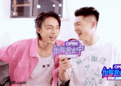 Two Young Men Laughing With Open Sign GIF