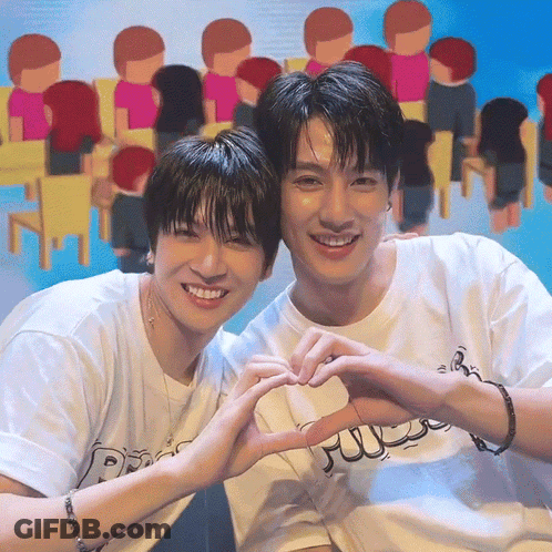 Two Young Men Making A Heart Shape With Their Hands In Front Of A Crowd GIF